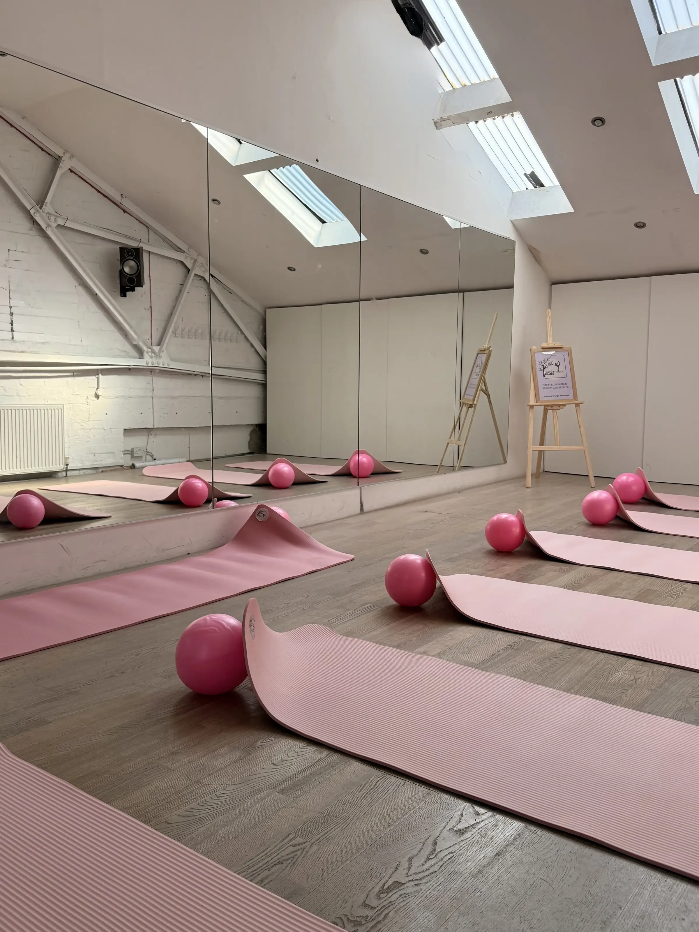 Yoga and pilates mats laid out in Studio 28 before a morning class