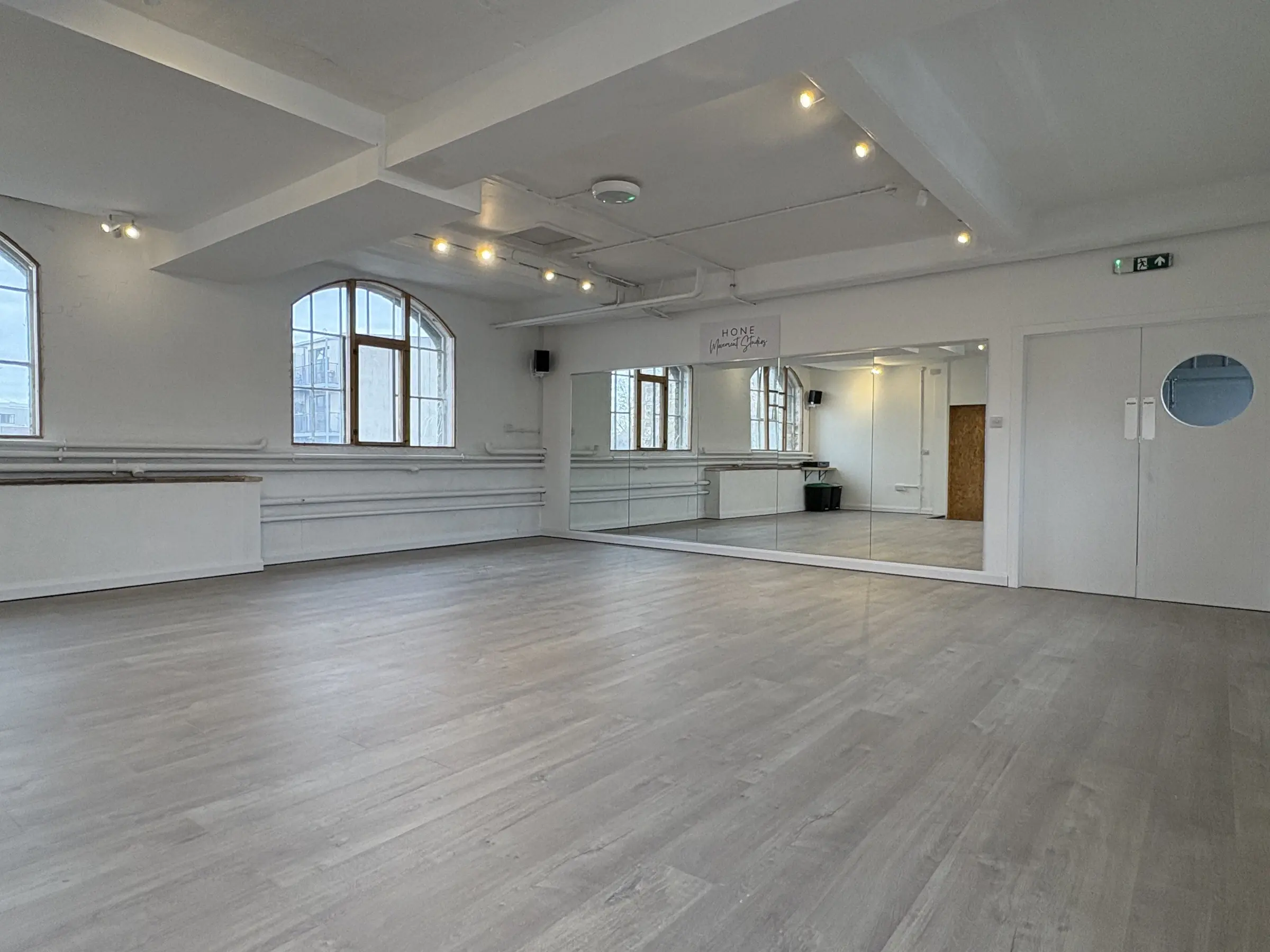 Studio 49: timber floor, full-height mirrors and arched warehouse windows