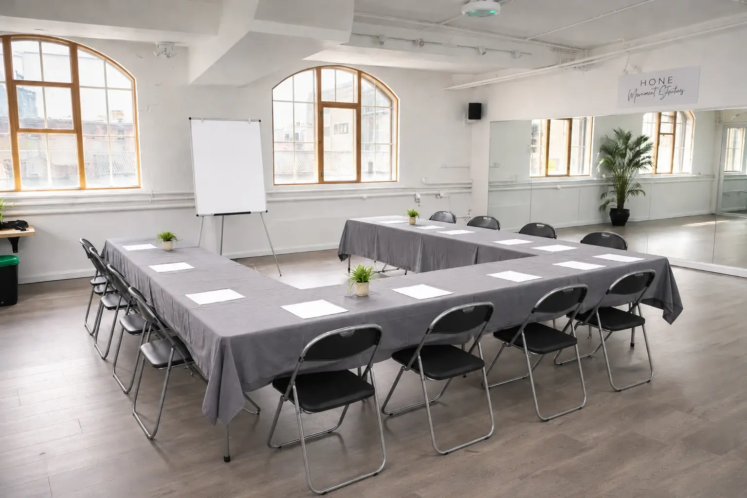 Table, chairs and whiteboard arranged for a meeting in Studio 49